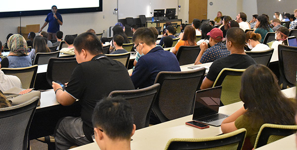 Students listening to presentation at Graduate Institute Orientation