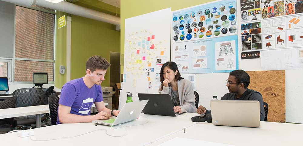 A group of three students working together